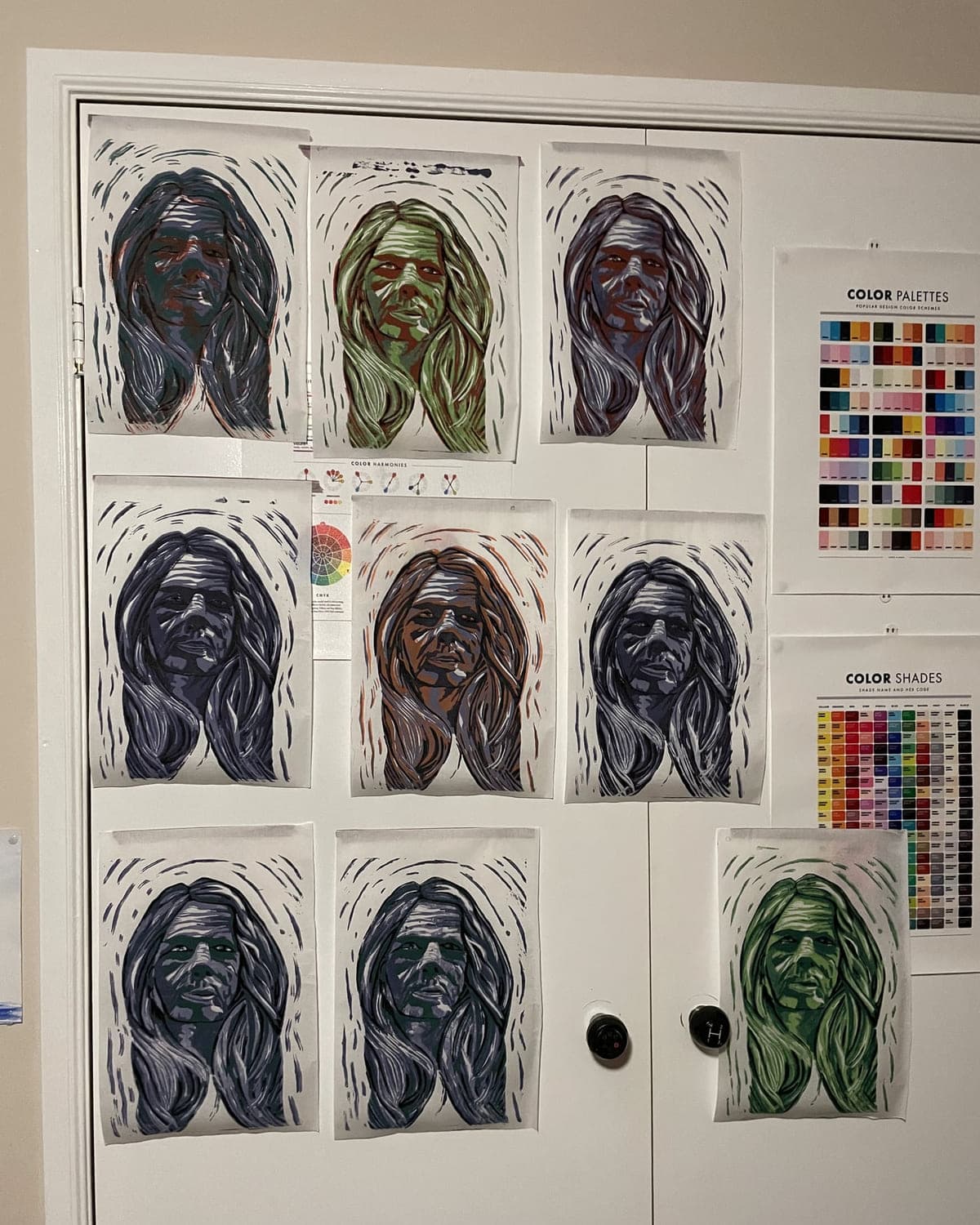 Studio doors hung with a full series of reduction-print portrait proofs
