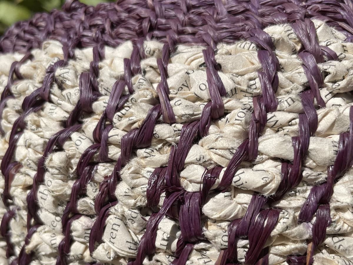 Close detail of purple and cream coiled stitching